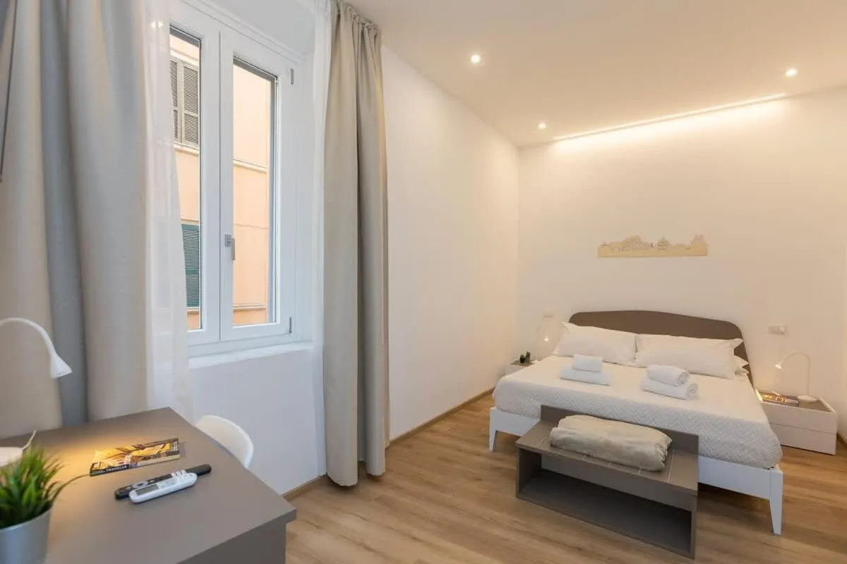 Bed in Colosseum Holidays - Three-Bedroom Apartment