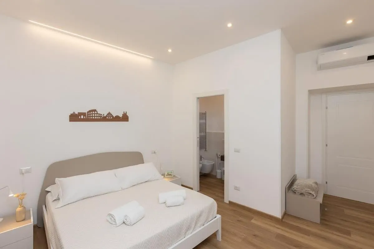 Bed in Colosseum Holidays - Three-Bedroom Apartment