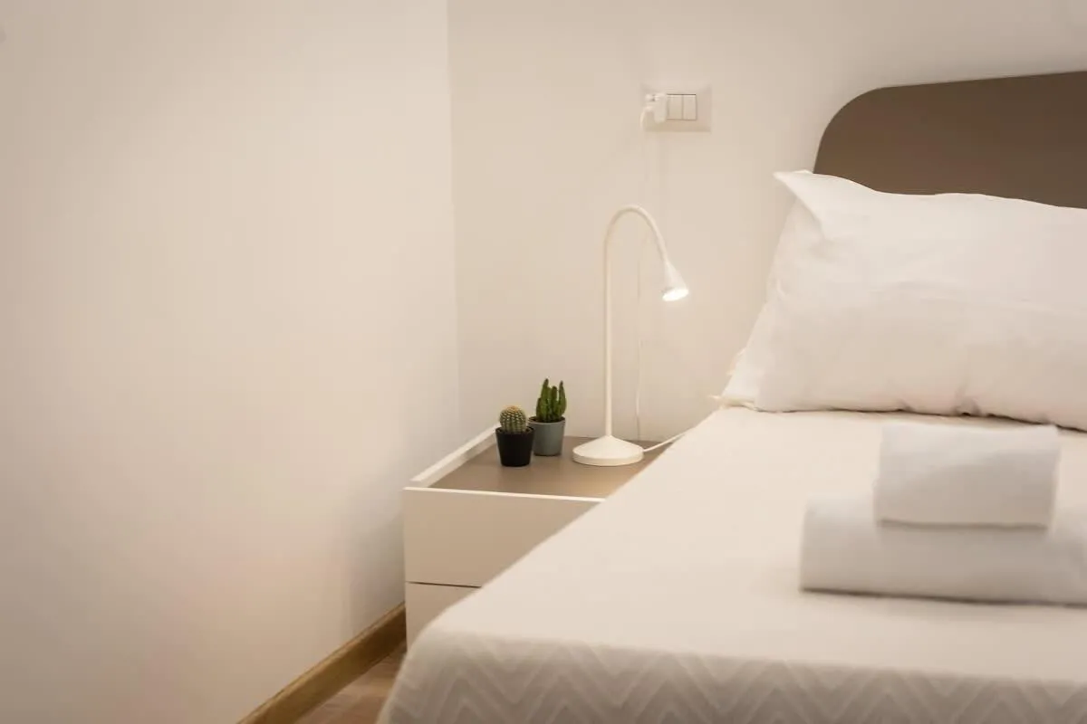 Bed in Colosseum Holidays - Three-Bedroom Apartment