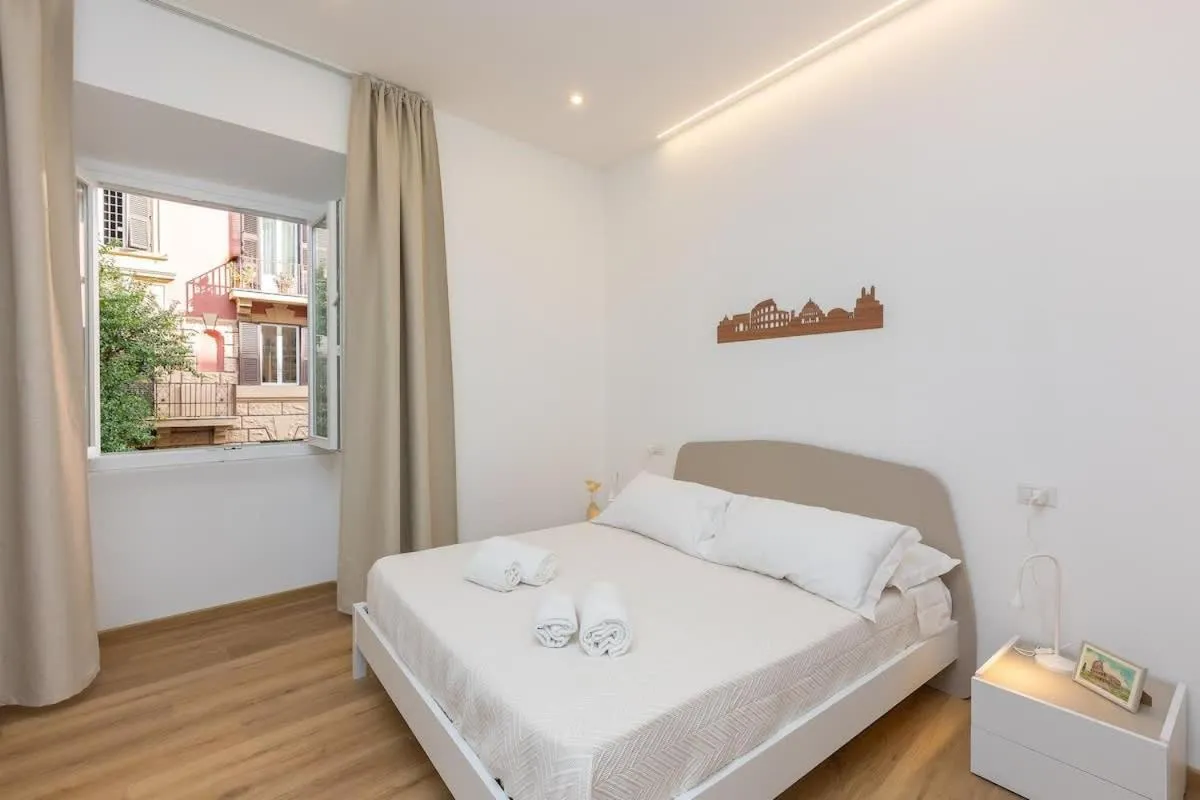 Bed in Colosseum Holidays - Three-Bedroom Apartment
