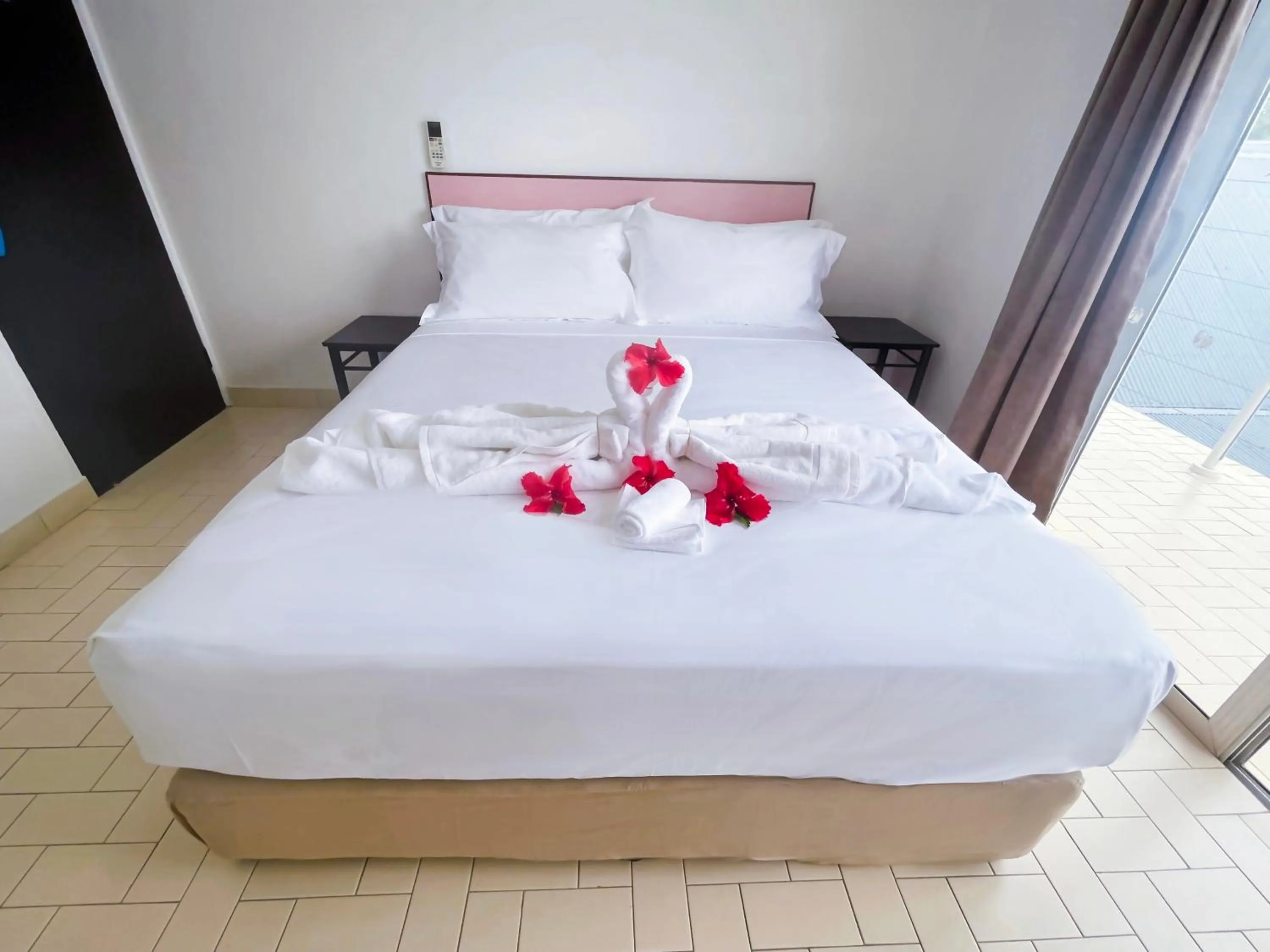 Bed in Coconut Palms Resort & Diamond Casino