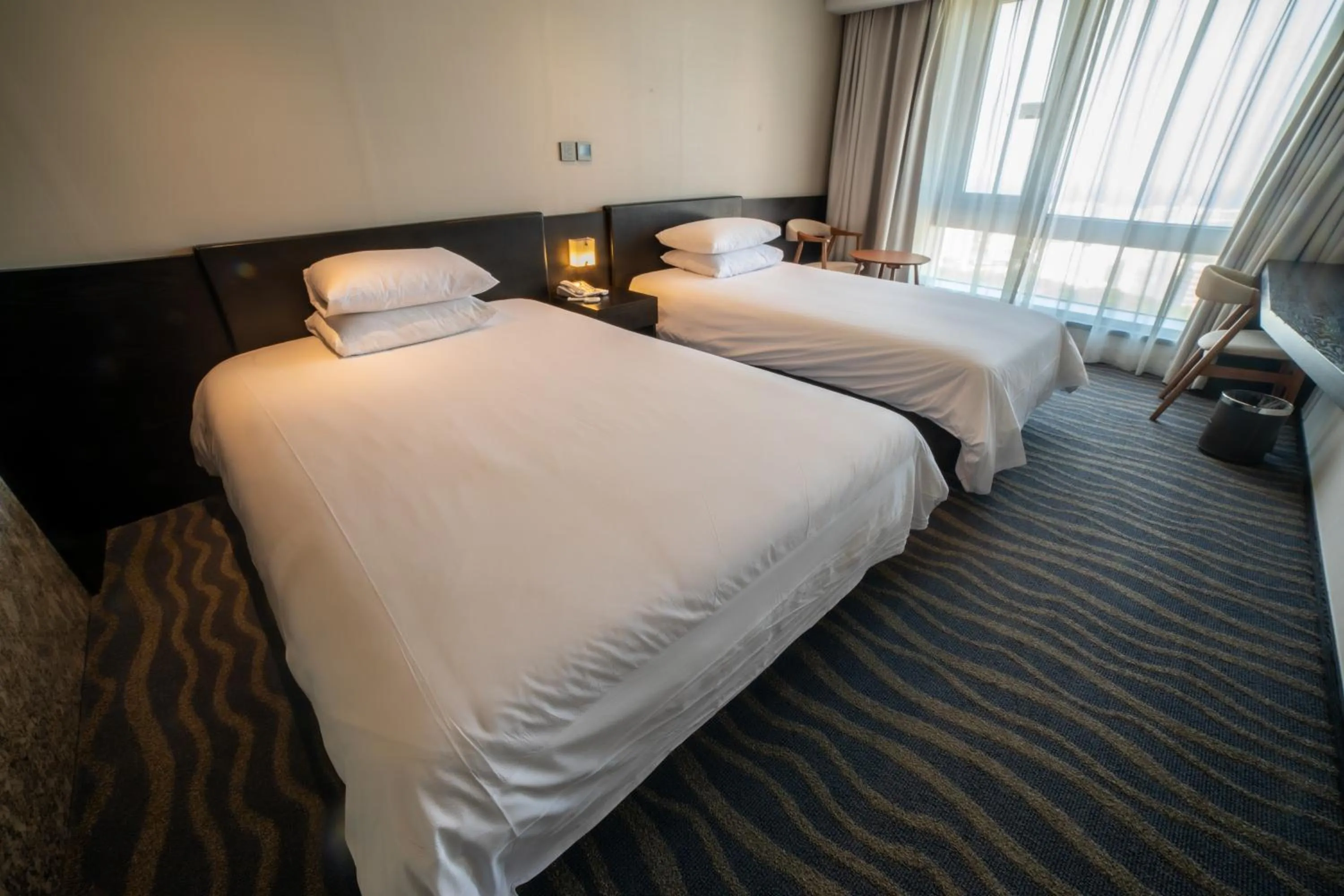 Bed in J-Grand Hotel