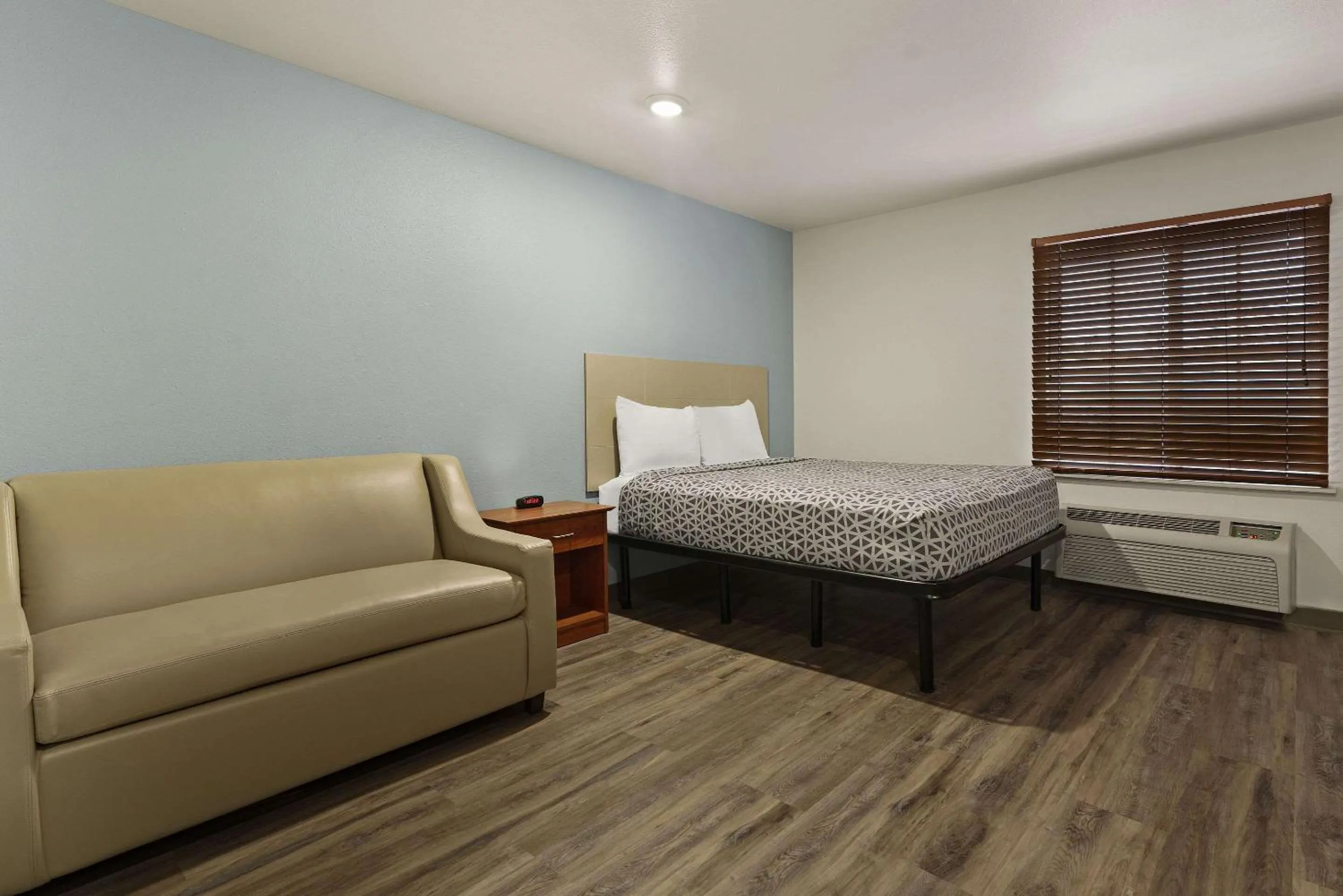 Bedroom in WoodSpring Suites Greenville Central I-85