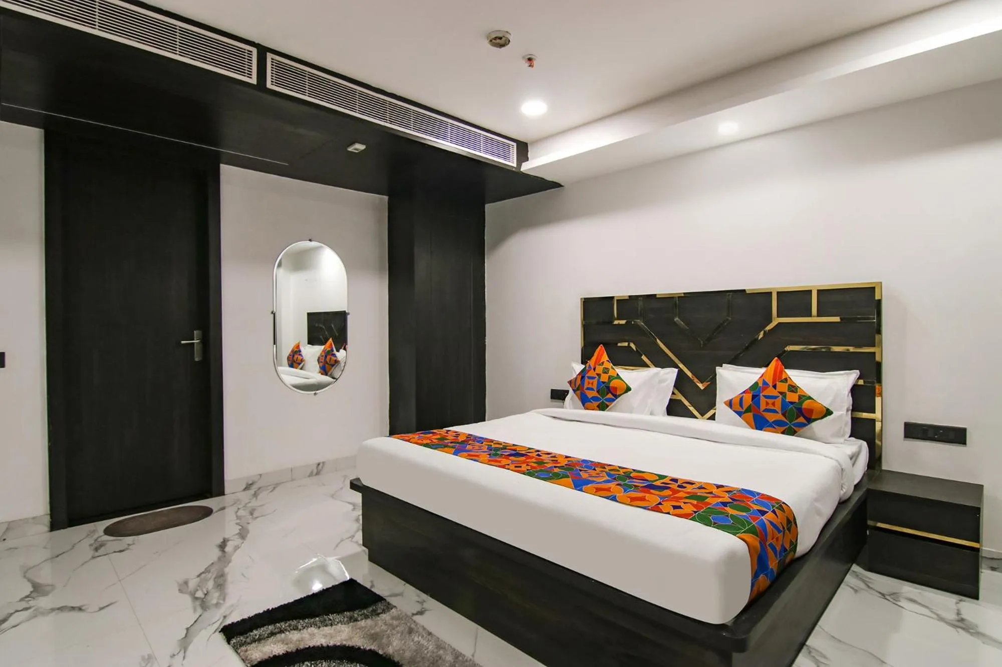 Bed in FabHotel Sky Suites Karkardooma