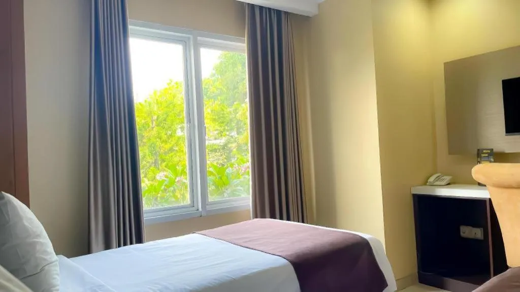 Bed in Rizen Premiere Hotel