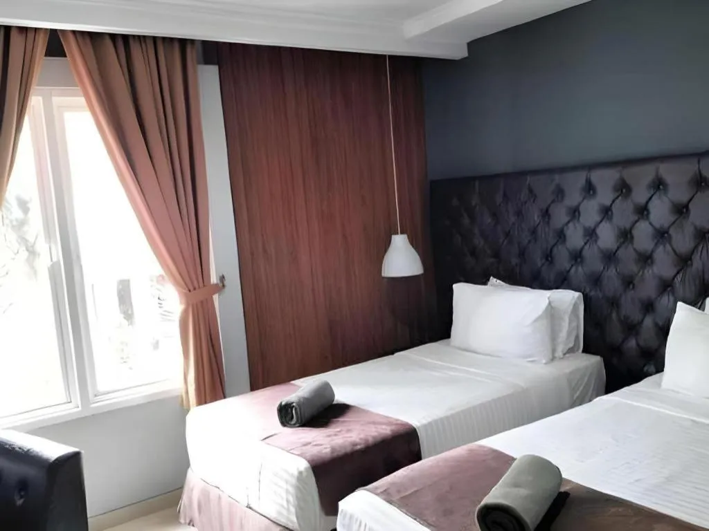 Bed in Rizen Premiere Hotel