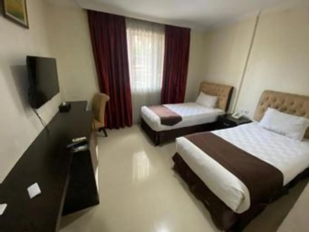 Bed in Rizen Premiere Hotel