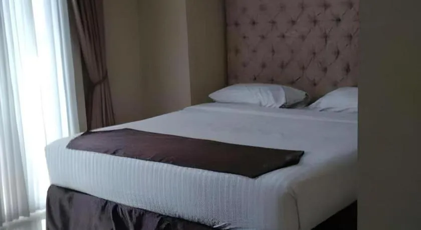 Bed in Rizen Premiere Hotel