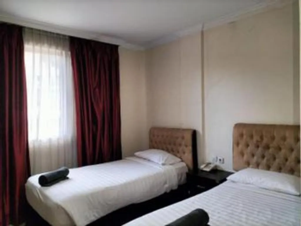 Bed in Rizen Premiere Hotel