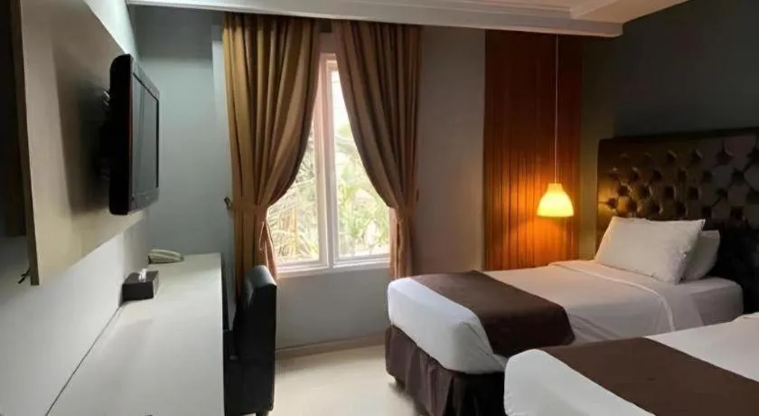 Bed in Rizen Premiere Hotel