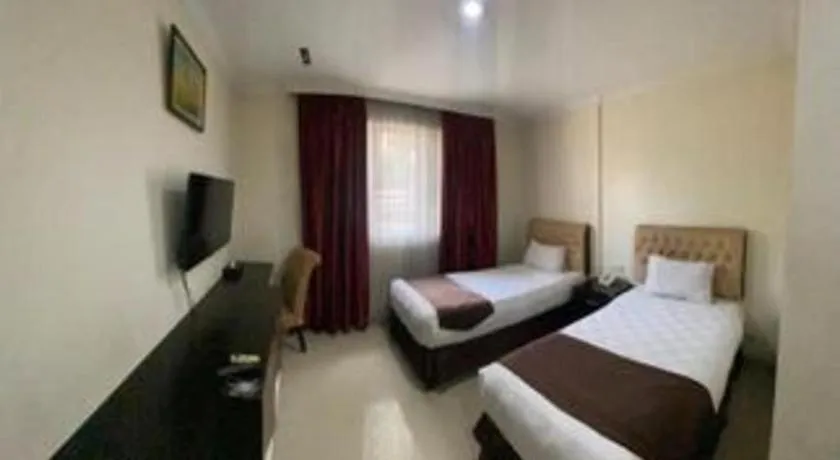 Bed in Rizen Premiere Hotel