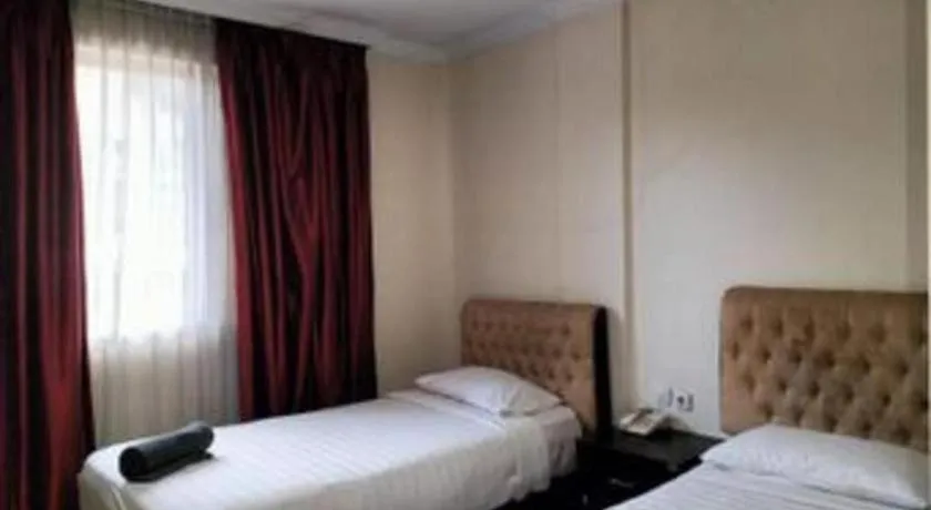 Bed in Rizen Premiere Hotel