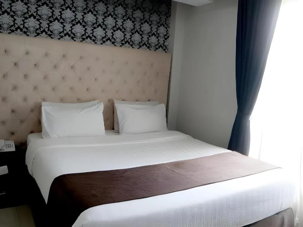 Bed in Rizen Premiere Hotel
