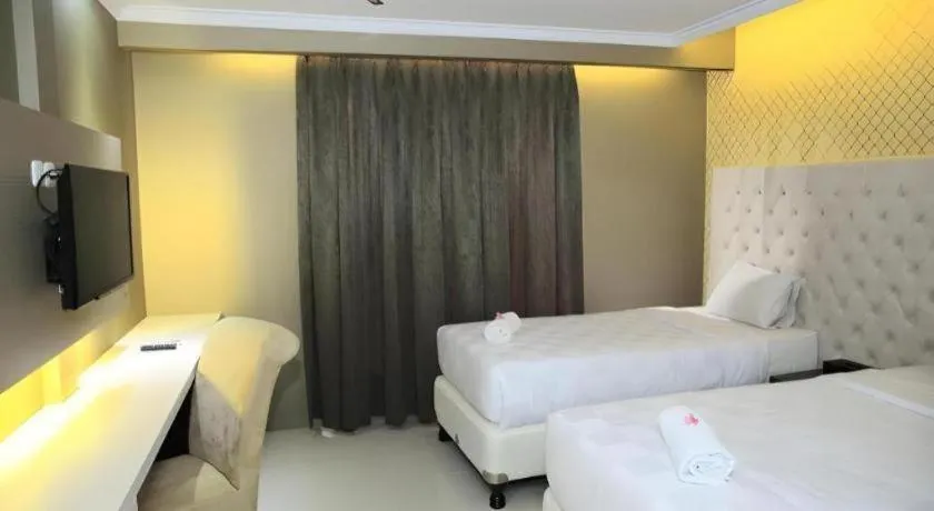 Bed in Rizen Premiere Hotel