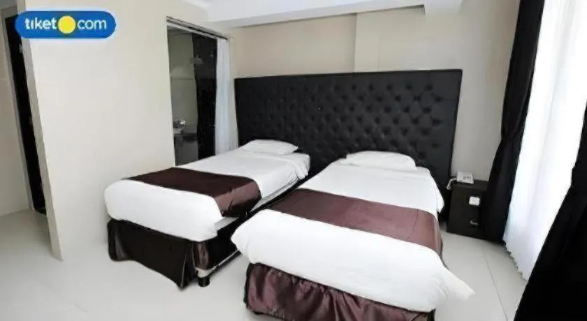 Bed in Rizen Premiere Hotel