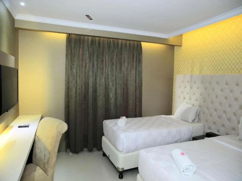 Bed in Rizen Premiere Hotel