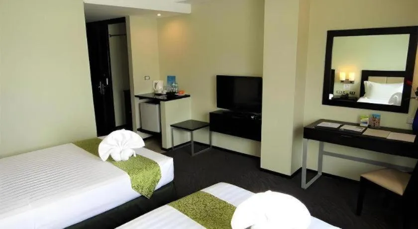 Bed in Mallberry Suites Business Hotel