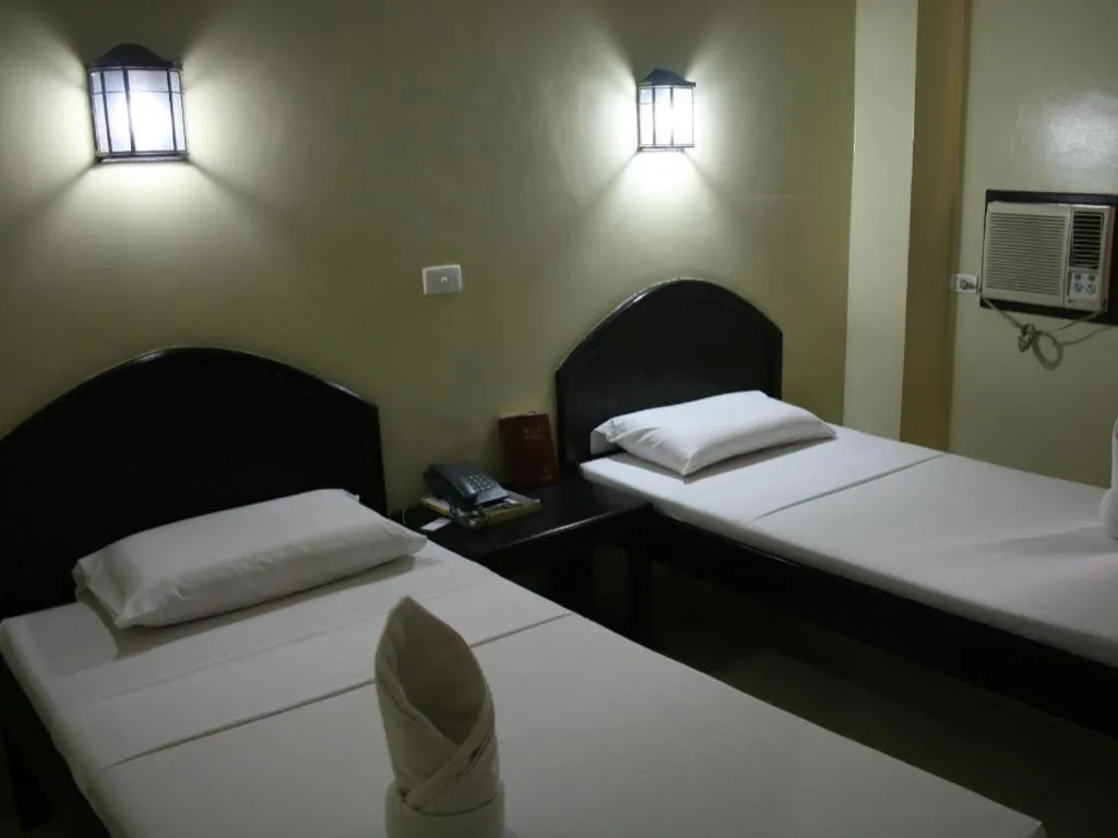 Bed in Sampaguita Suites Plaza Garcia