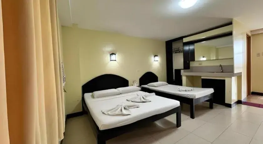 Bed in Sampaguita Suites Plaza Garcia Bed in Sampaguita Suites Plaza Garcia