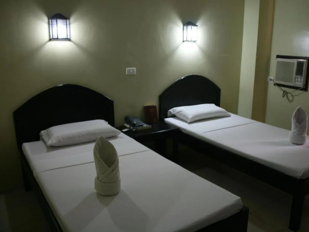 Bed in Sampaguita Suites Plaza Garcia