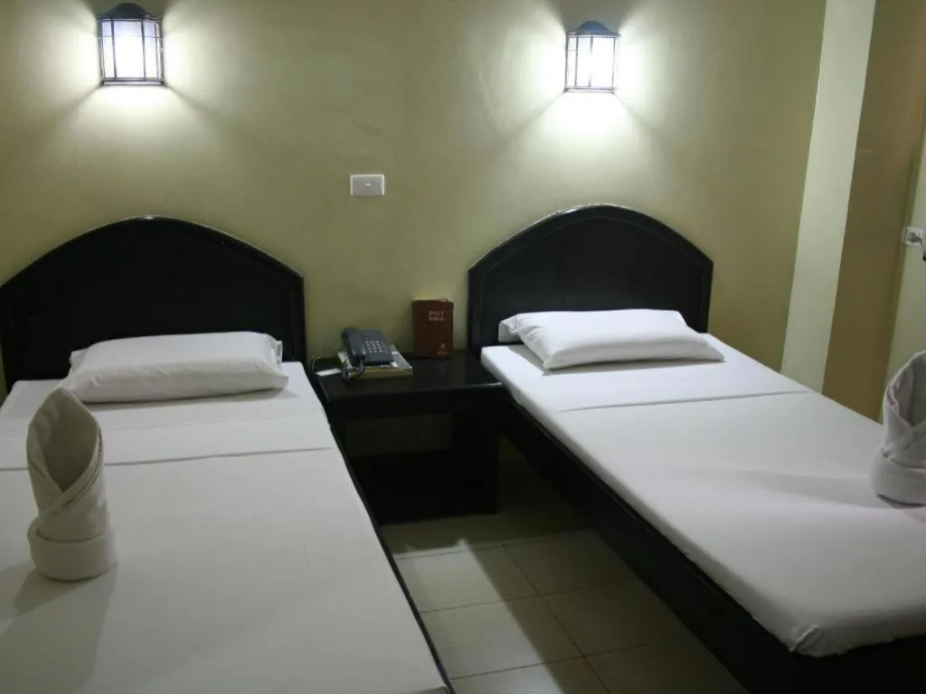 Bed in Sampaguita Suites Plaza Garcia
