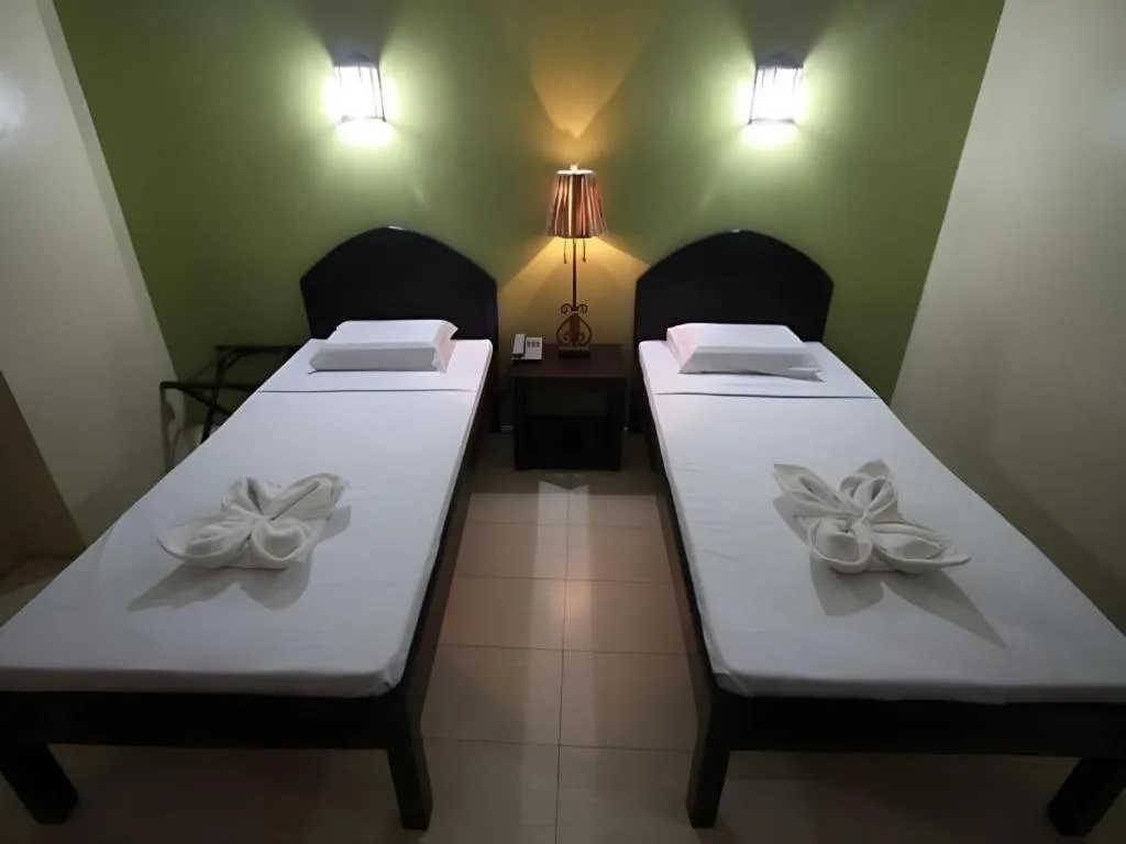 Bed in Sampaguita Suites Plaza Garcia