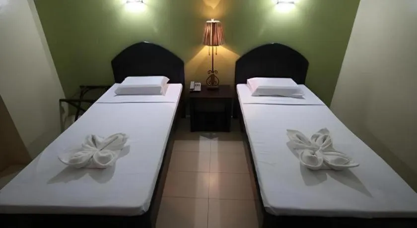 Bed in Sampaguita Suites Plaza Garcia