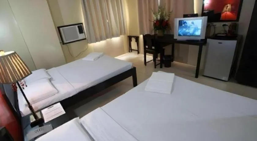 Bed in Sampaguita Suites Plaza Garcia