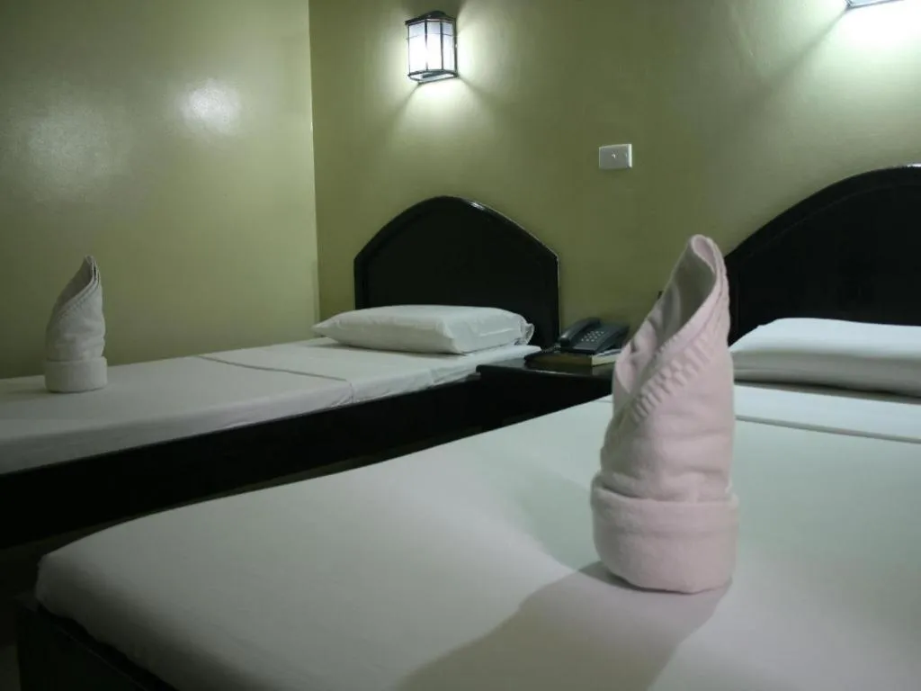 Bed in Sampaguita Suites Plaza Garcia