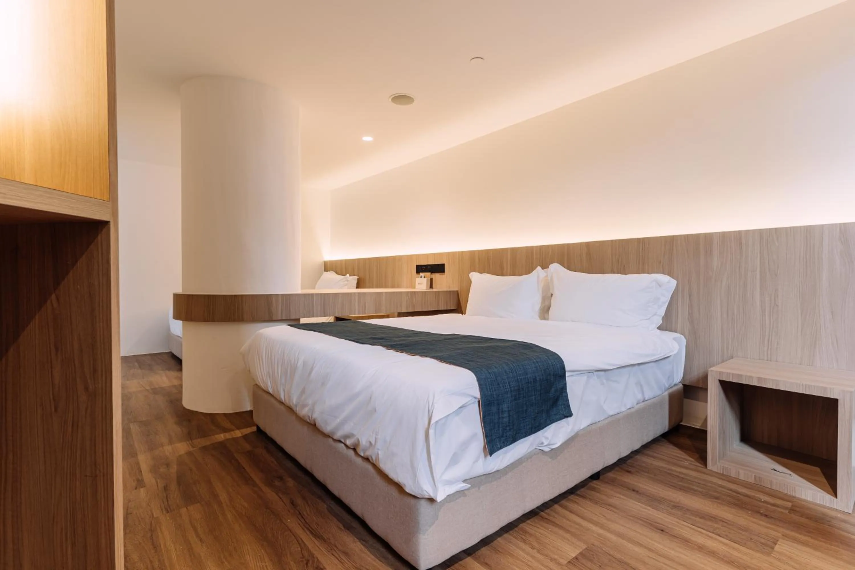 Bed in Impiana by Roxy Hotel