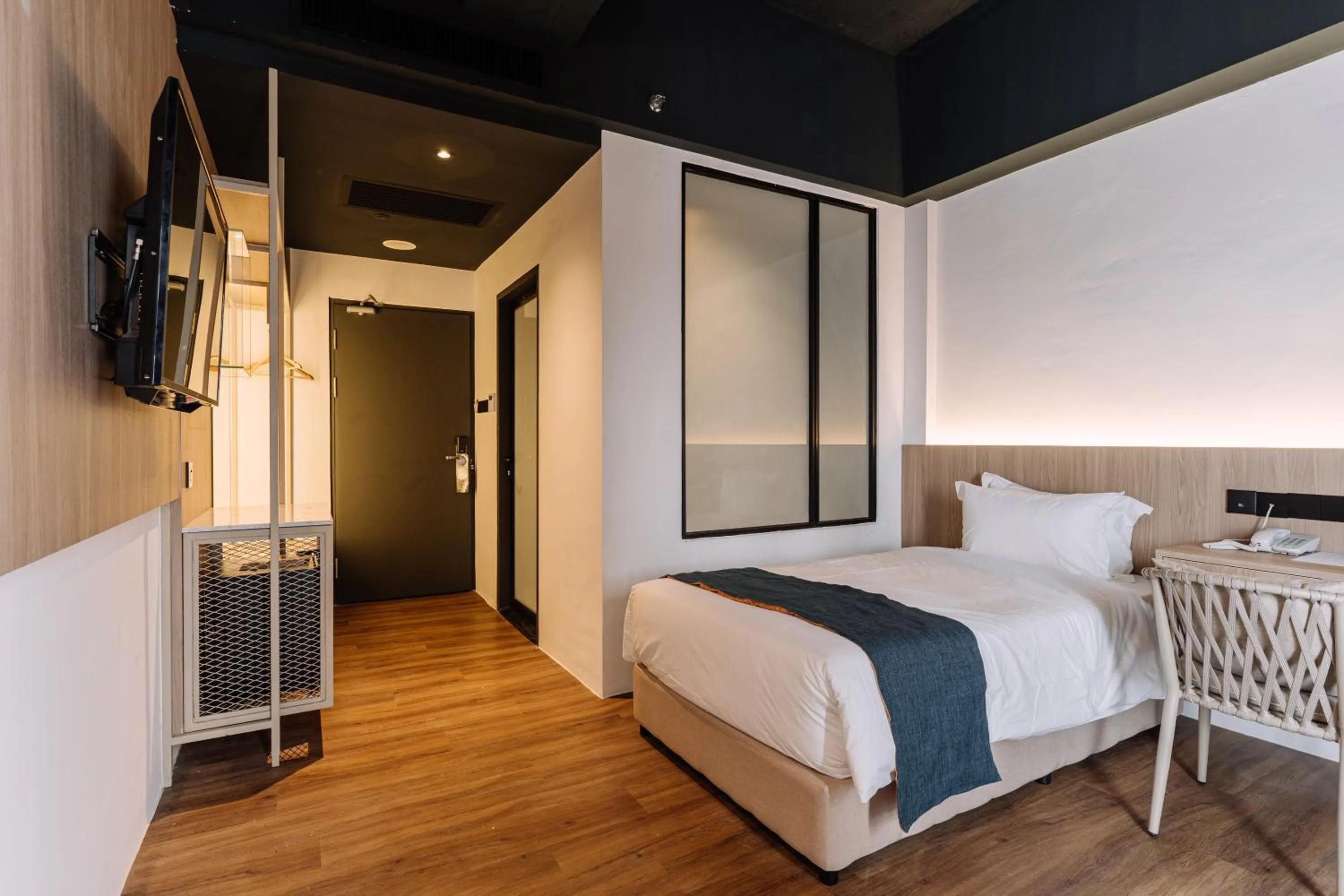 Bed in Impiana by Roxy Hotel