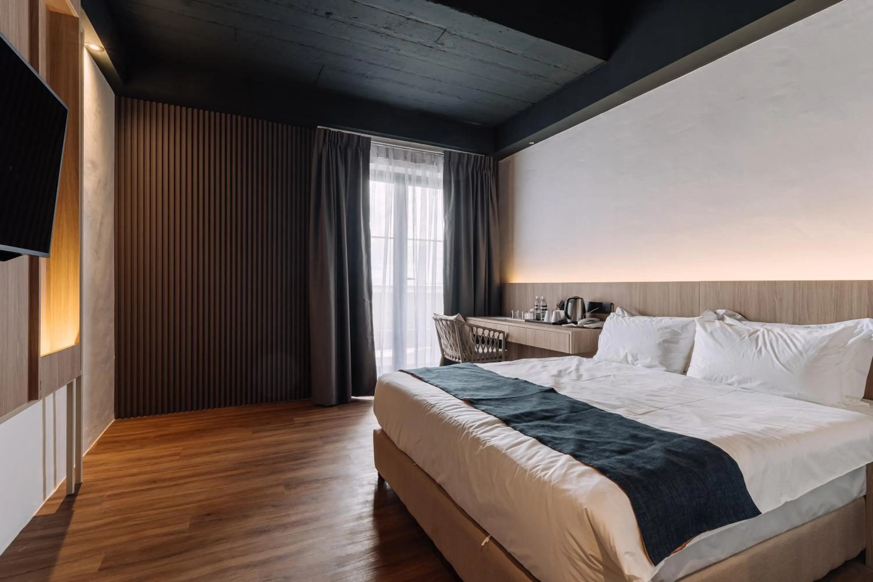 Bed in Impiana by Roxy Hotel