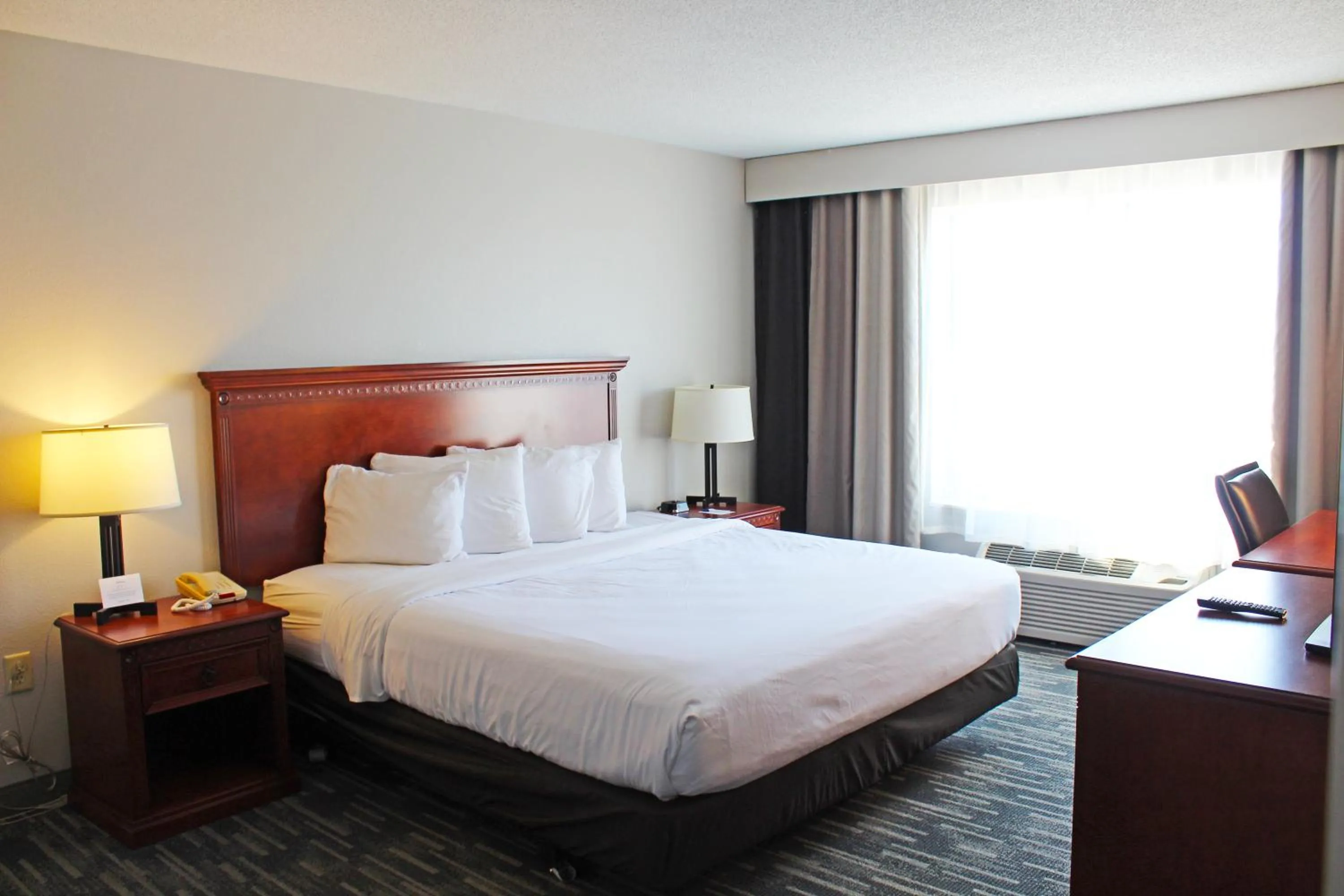 Bed in Independence Stay Hotel & Suites