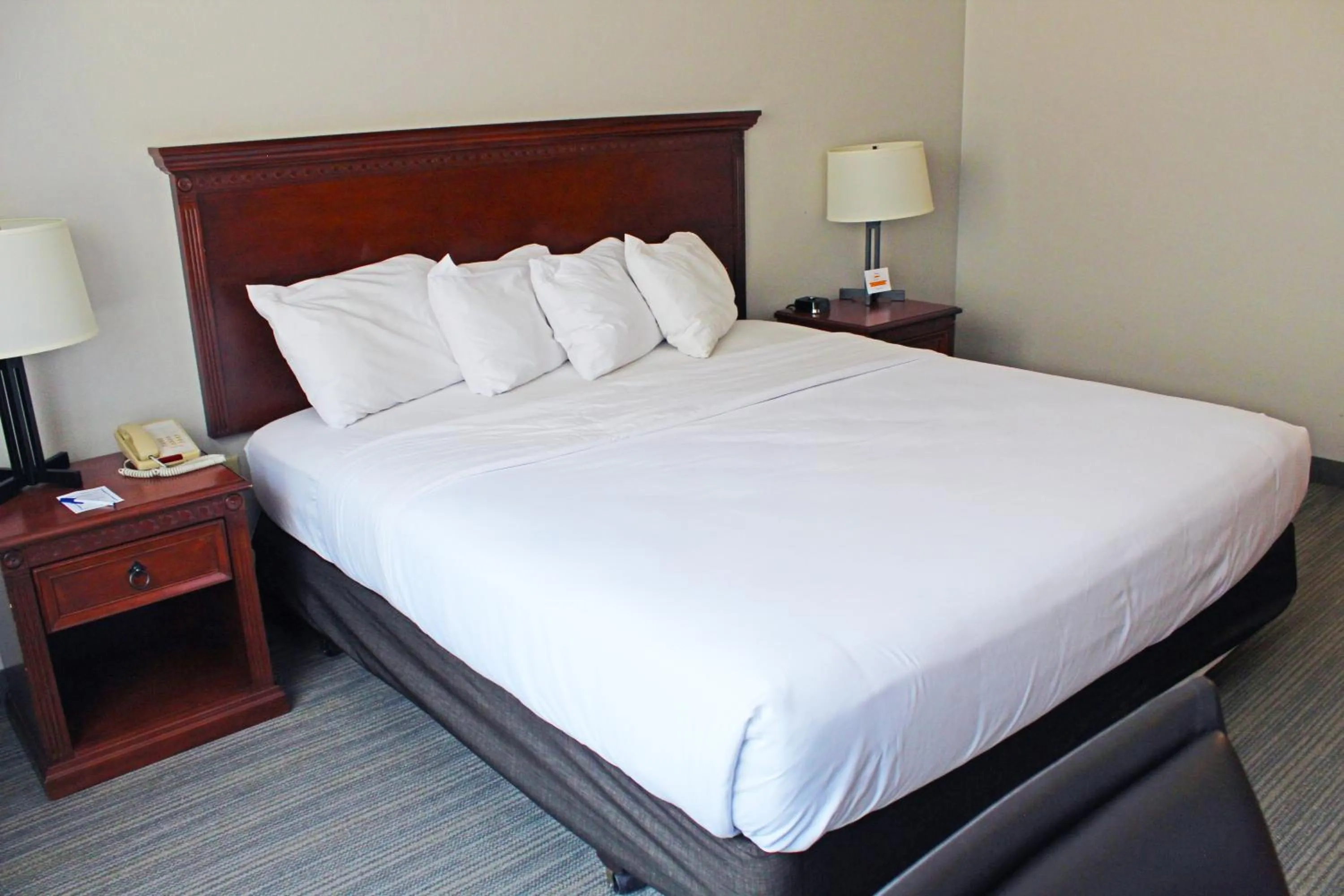 Bed in Independence Stay Hotel & Suites