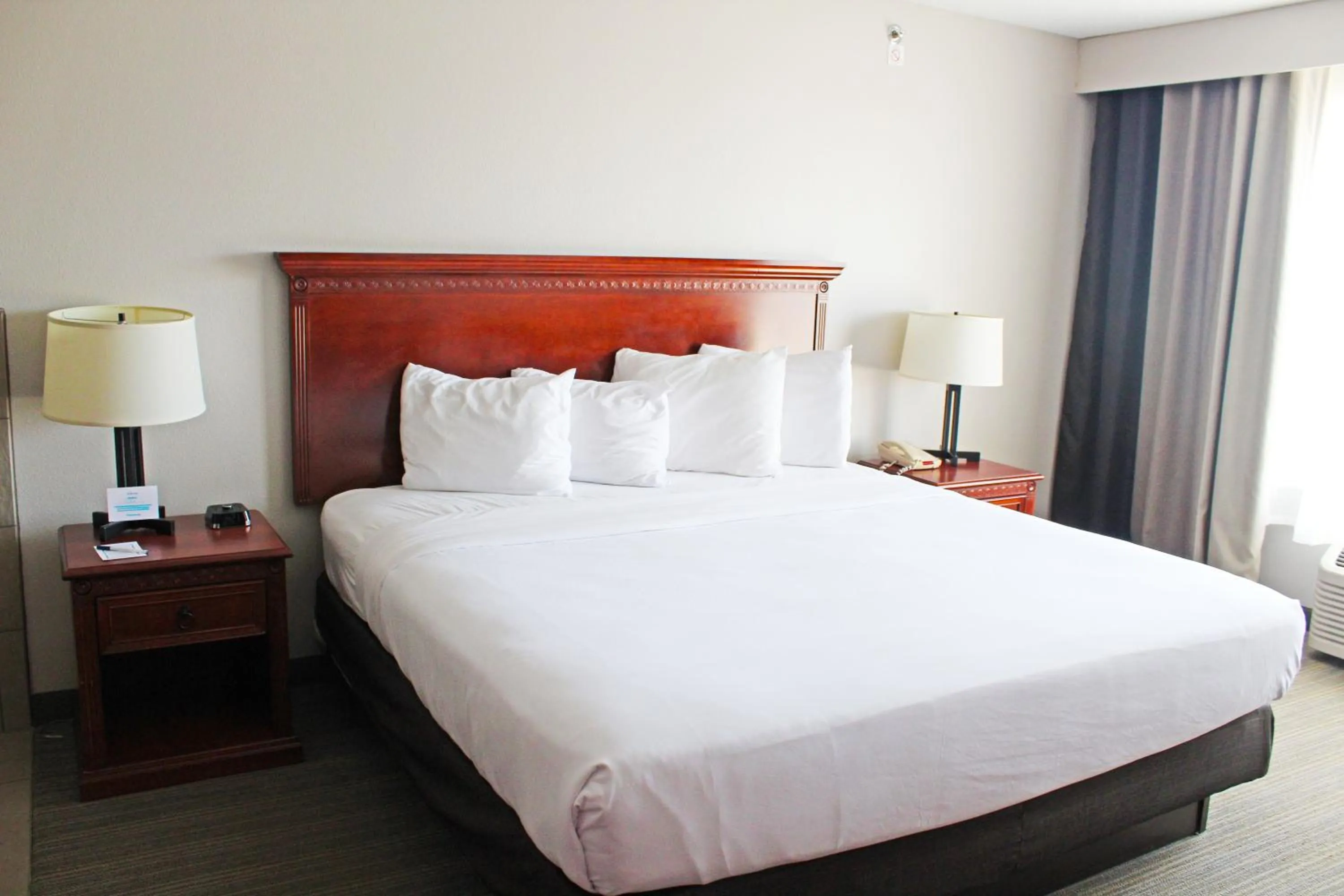 Bed in Independence Stay Hotel & Suites