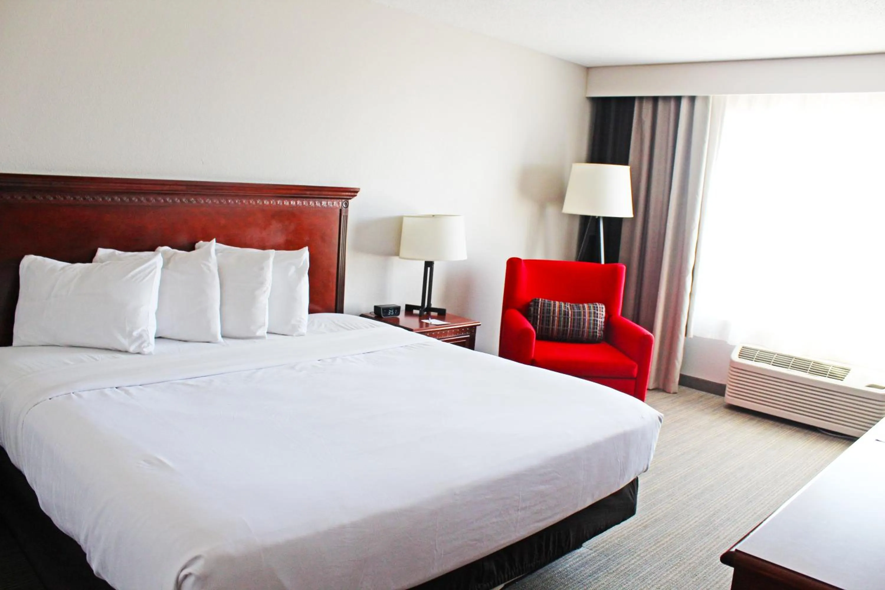 Bed in Independence Stay Hotel & Suites