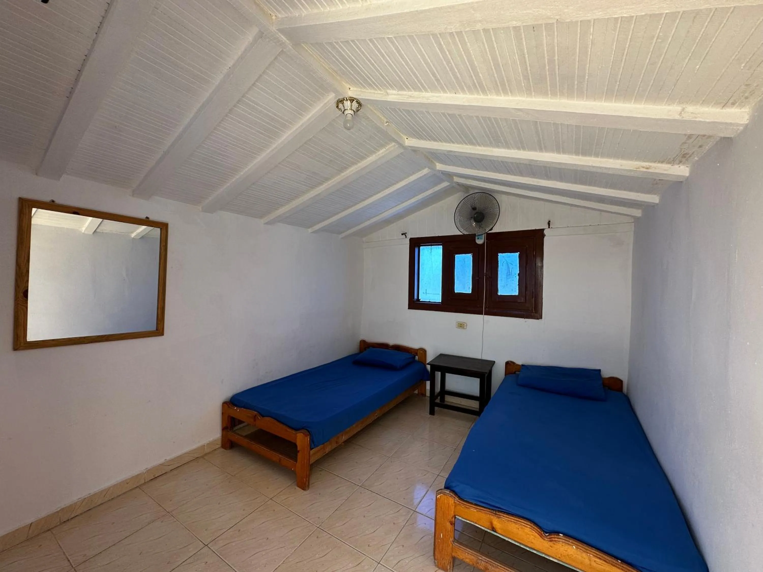 Bed in Seven Heaven Hotel And Diving Center