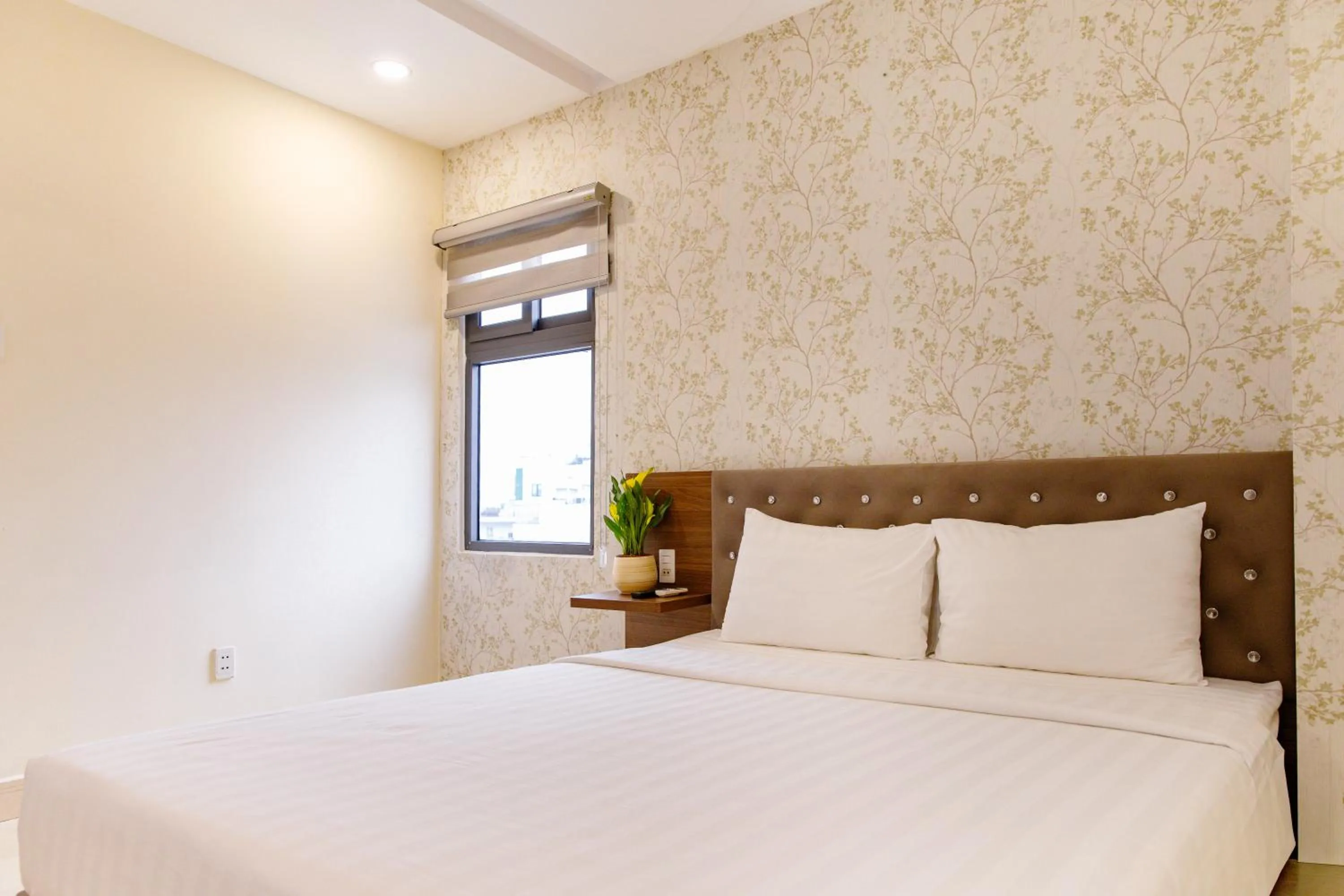 Bed in Boss Palace Hotel