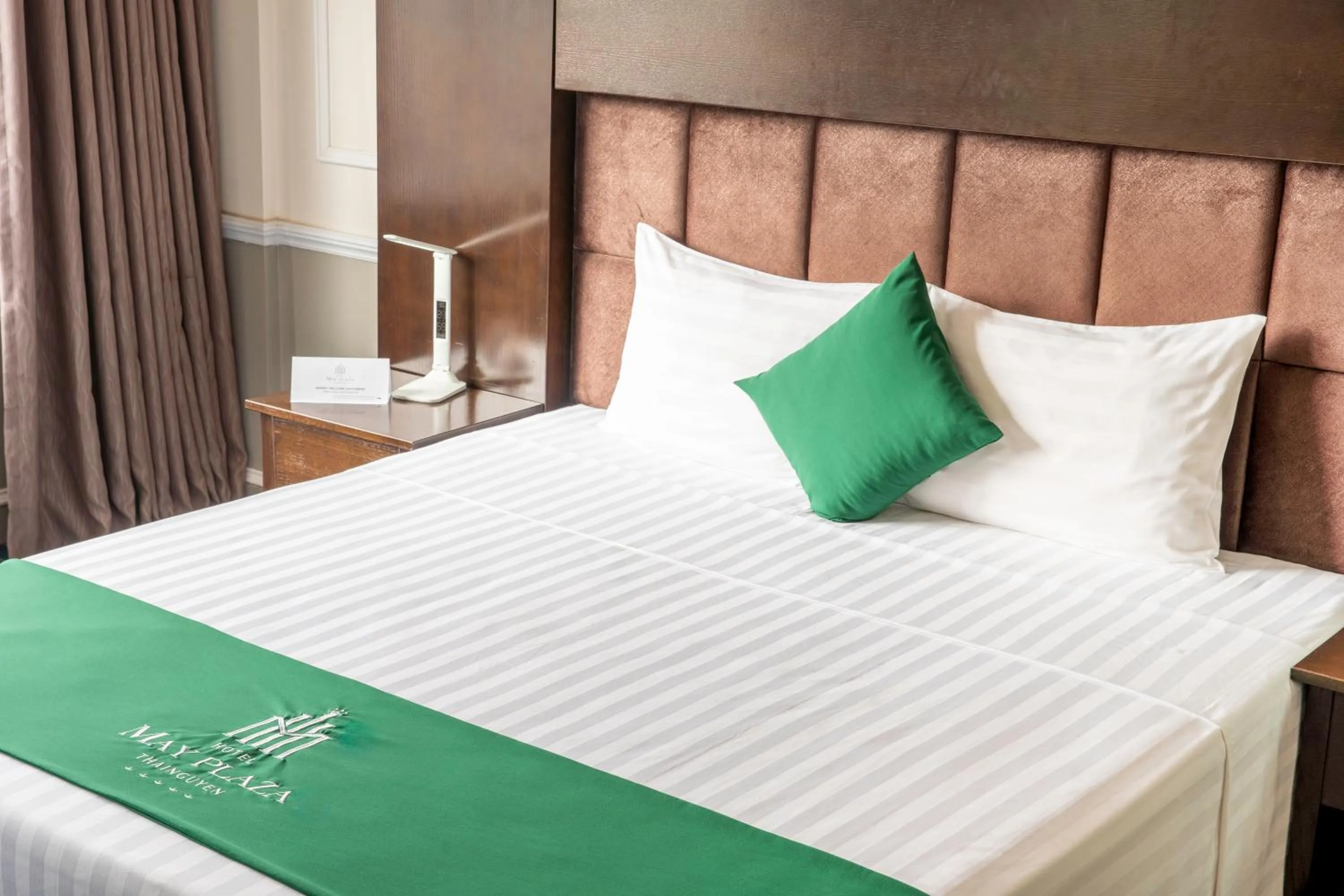 Bed in MAY PLAZA HOTEL