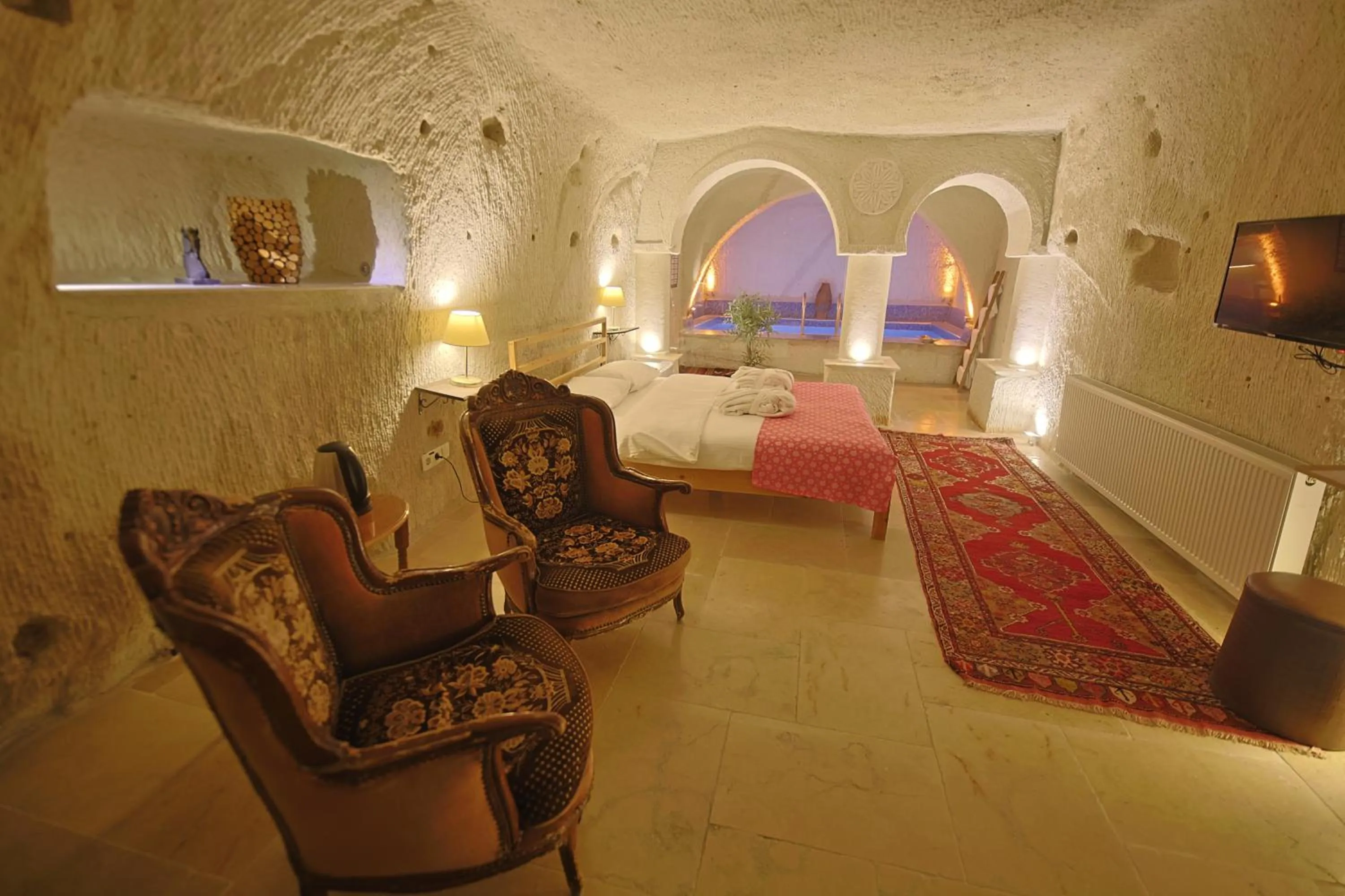 Seating area, Bed in My Cave Suites