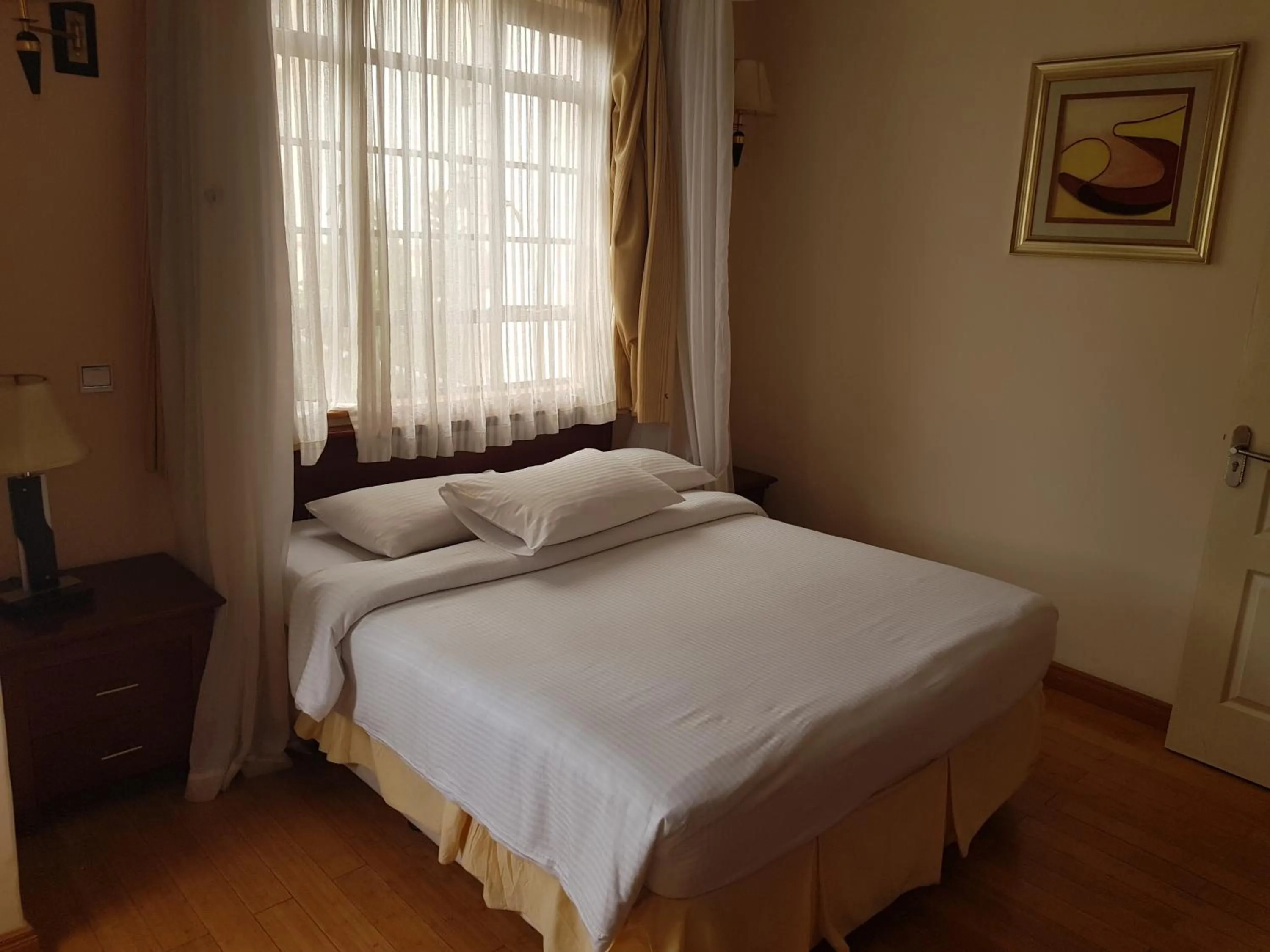 Bed in Natural Oak Apartments