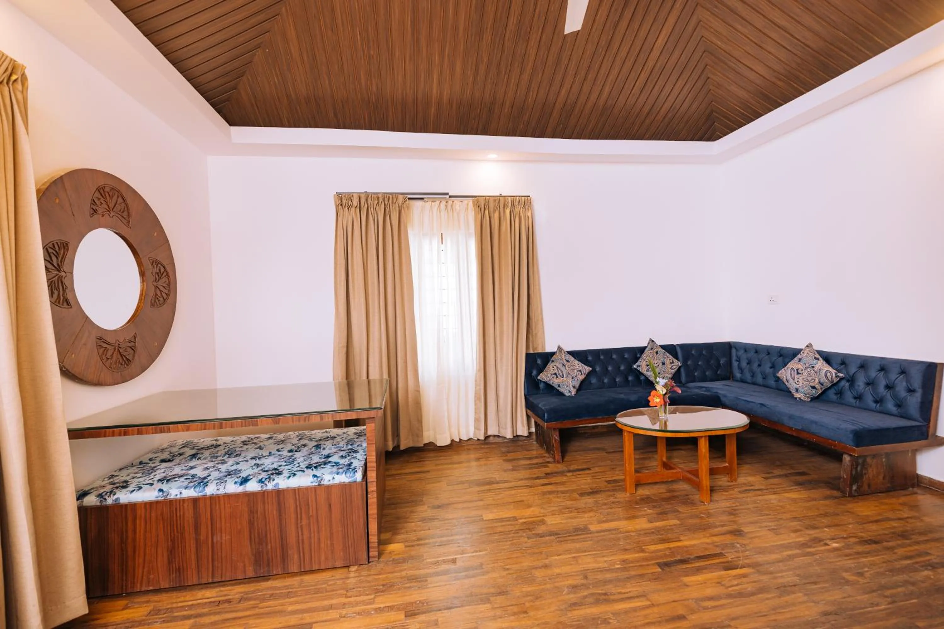 Seating area, Bed in Elixir Woods Luxury Resort And Spa, Munnar