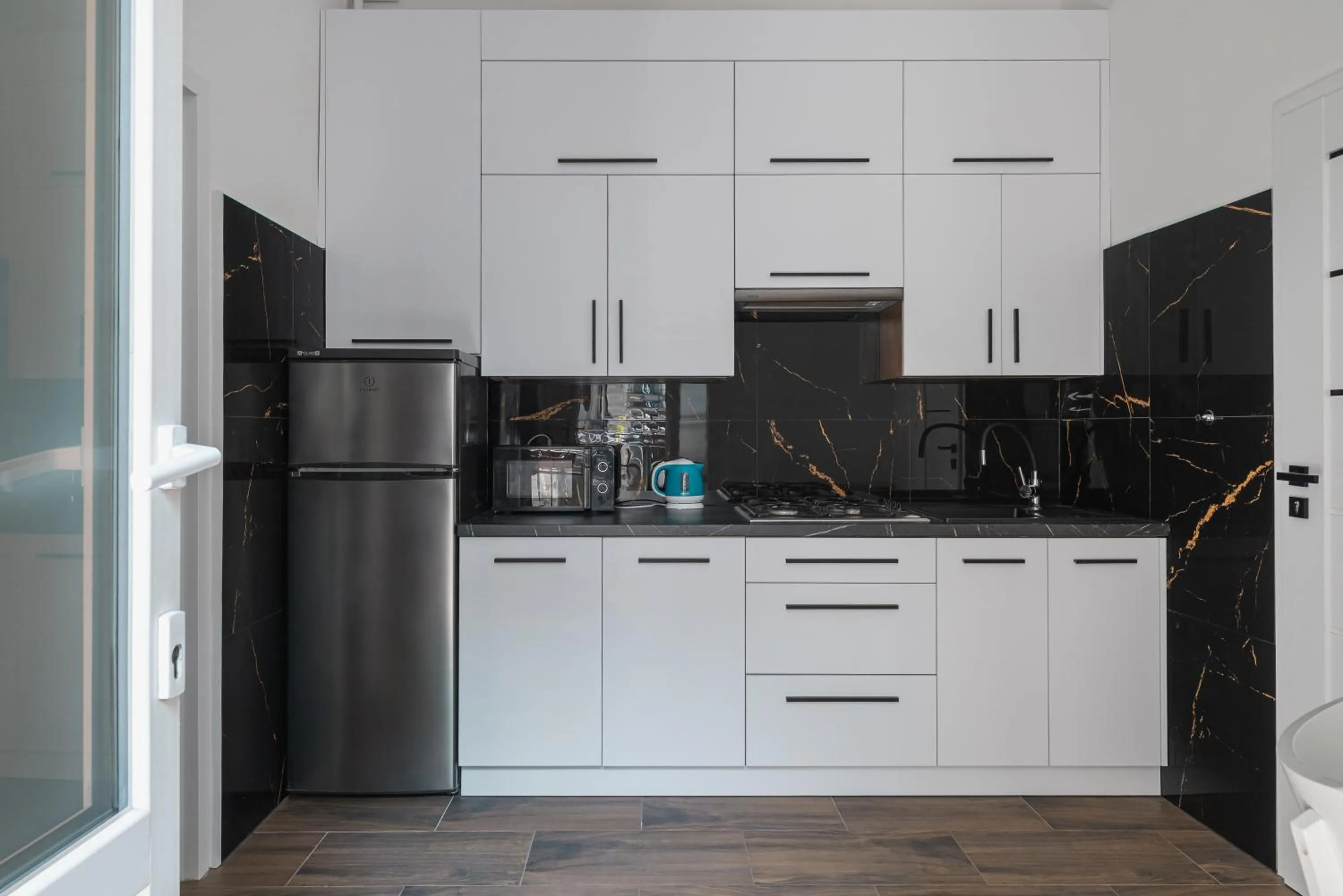 Kitchen or kitchenette in Queen Apartments