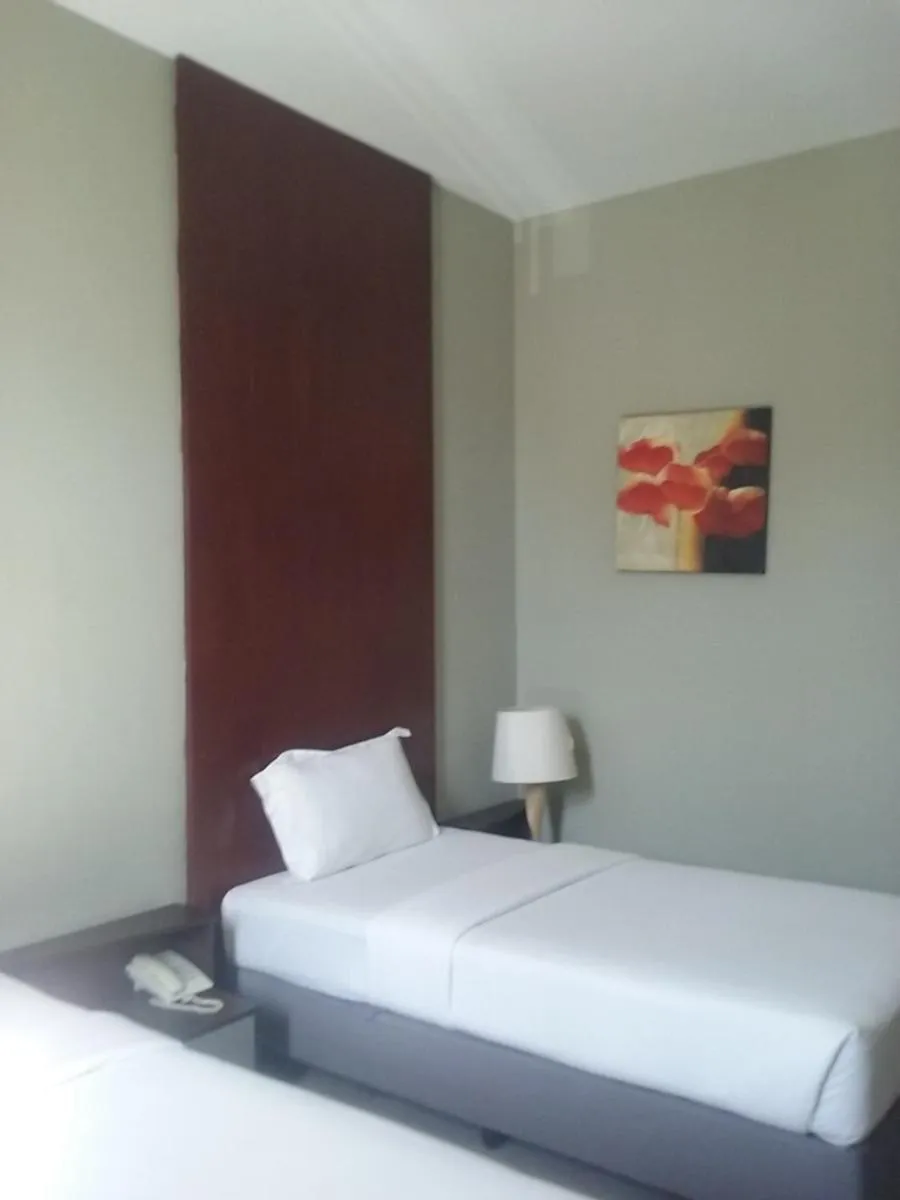 Bed in Ginasuite Hotel