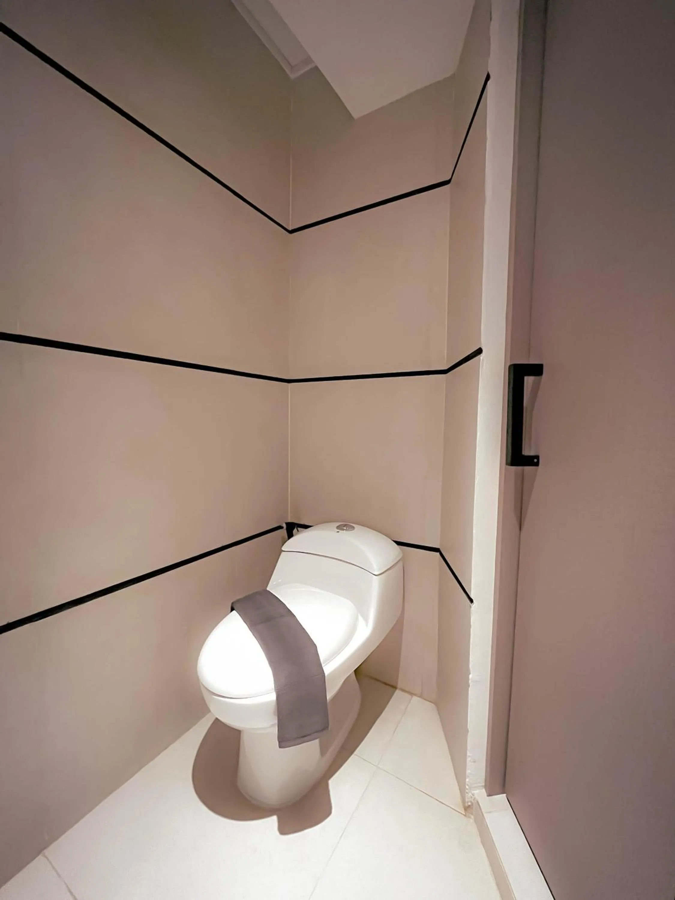 Toilet in Qube Hotel by 98hospitality
