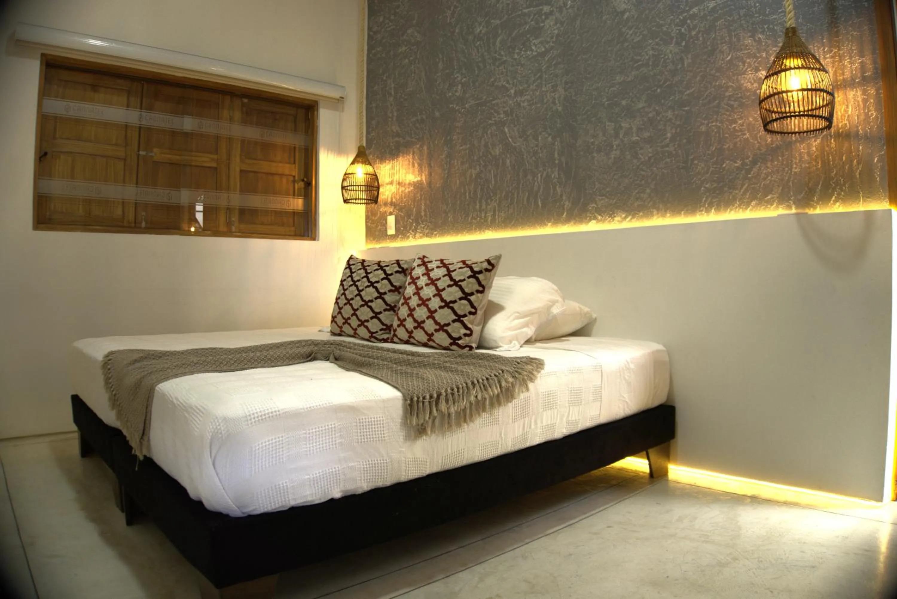 Bed in Cannatel Exclusive Hotel