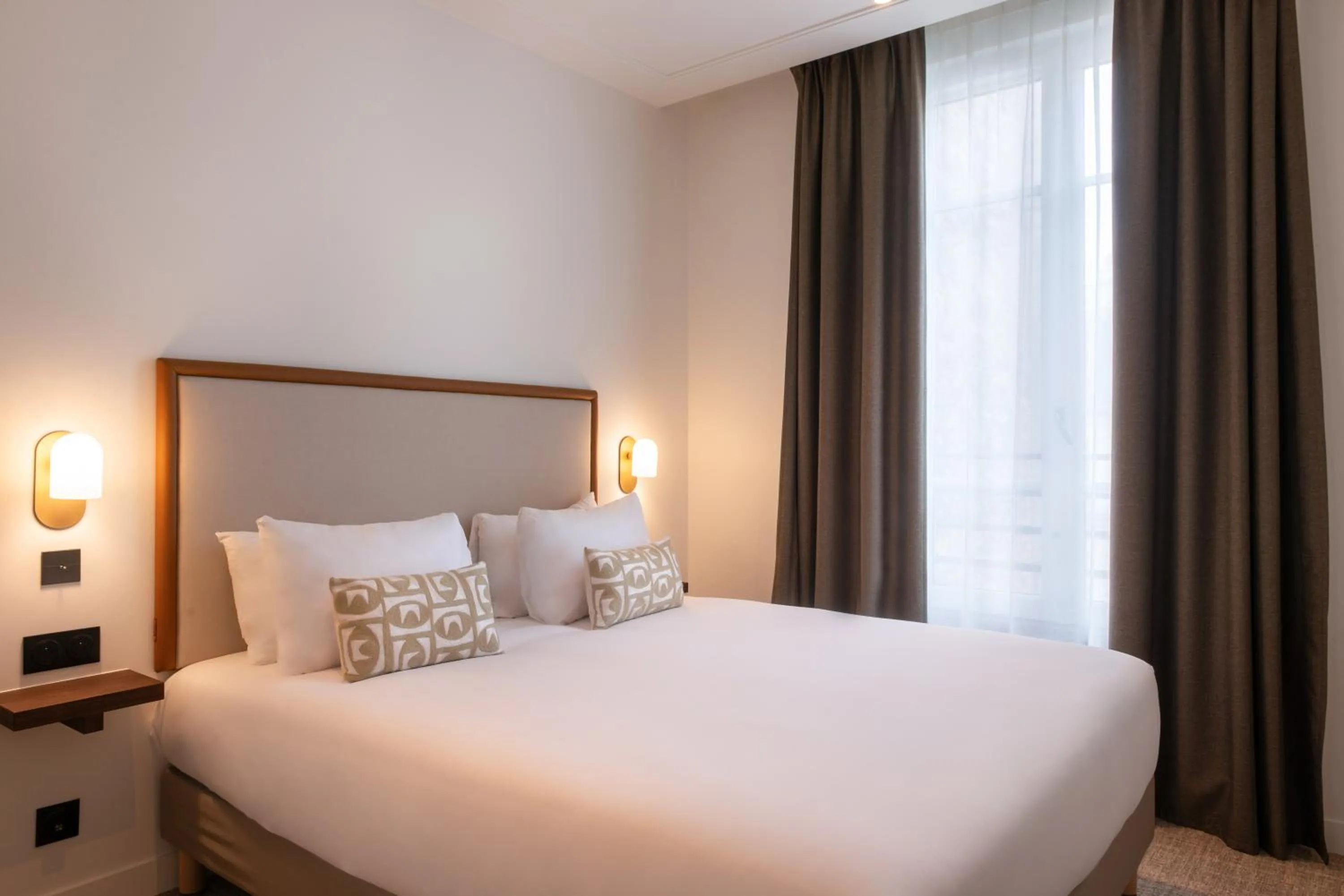 Bed in Le Lampika Hôtel