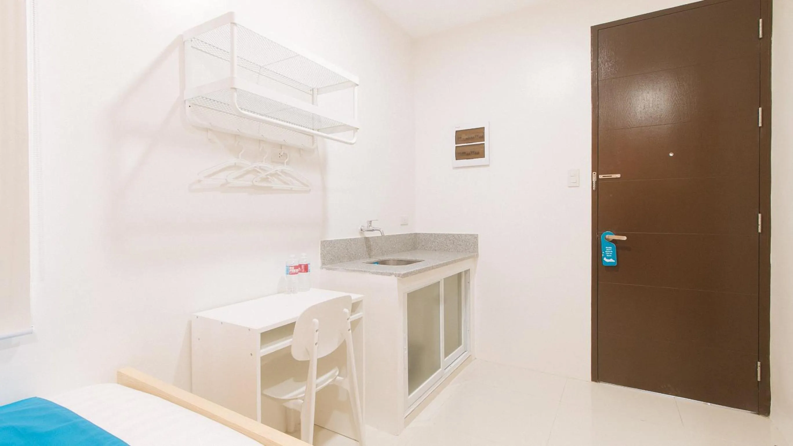 Seating area in Sans Hotel at One JD Place Makati by RedDoorz