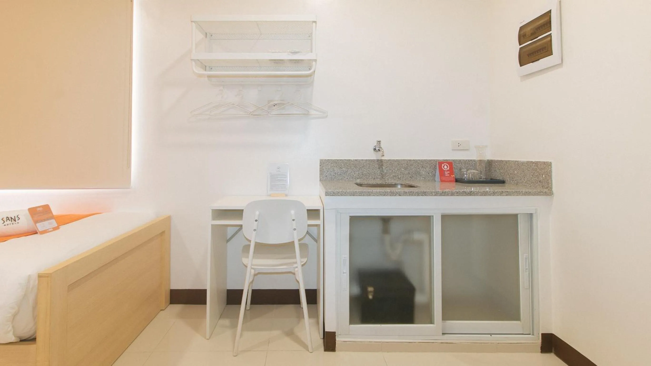 Seating area in Sans Hotel at One JD Place Makati by RedDoorz