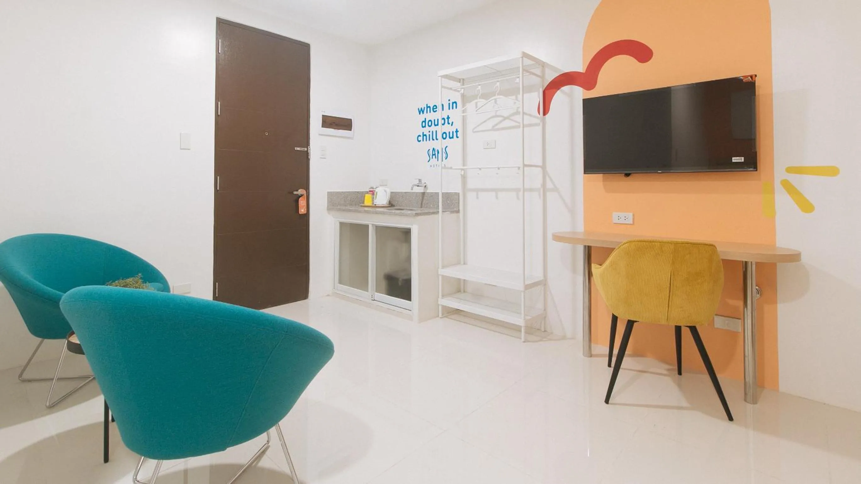 Seating area in Sans Hotel at One JD Place Makati by RedDoorz